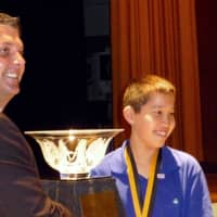 <p>New Rochelle Middle School student Jake Gallin being awarded his trophy for his volunteer work.</p>