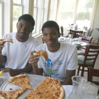 <p>Westhill players - senior Joshua Gordon (left) and junior Voshon Natteal said the pizza tasted &quot;excellent - on Norwalk&#x27;s tab.&quot;</p>