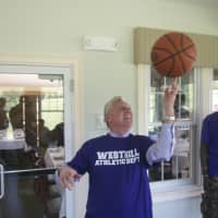 <p>Mayor Harry Rilling shows off his basketball skills. </p>