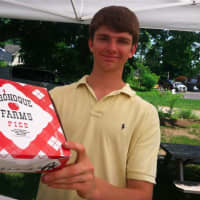 <p>Joshua Kreitler, of the family-owned Shelton-based Oronque Farms, holds a pie at the Wilton Farmers Market on Wednesday.</p>