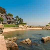 <p>The 6,000-square-foot Tudor mansion is located just steps from a private beach on Tavern Island. </p>