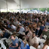<p>The crowd assembles under the tent on a warm Friday afternoon. </p>
