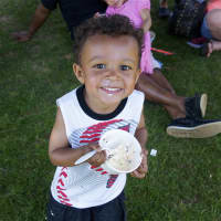 <p>A boy enjoys his cool ice cream on a hot day at the Ice Cream Social at the Lockwood-Mathews Mansion Museum in Norwalk on Sunday.</p>