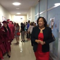<p>Briggs Principal Marie Allen checks out her graduating students. </p>