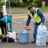 <p>Volunteers and workers set up to hand out water </p>