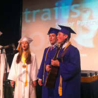 <p>A group of graduates prepare their song before the Darien High School graduation ceremonies Tuesday.</p>