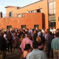 <p>Friends and family mill about following the graduation ceremonies at Darien High School on Tuesday.</p>