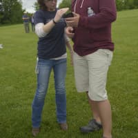 <p>WCSU Meteorology Club member Jennifer Dums and WCSU graduate student Paul Shupenis check weather conditions for the weather balloon launch on June 6.</p>