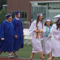 <p>Graduates march onto the field in their processional to start the graduation ceremonies at Fairfield Ludlowe on Wednesday. </p>