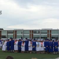 <p>The members of the Class of 2015 take their places under cloudy skies. </p>