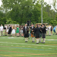 <p>Music accompanies the graduation, held on the Danbury High football field. </p>