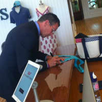 <p>Gov. Dannel P. Malloy signing a Vineyard Vines tie after a tour of the company&#x27;s new Stamford headquarters Thursday.</p>