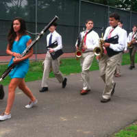 <p>Members of the band walk toward the football field for the graduation ceremonies. </p>