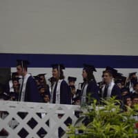 <p>The graduates line up to get their diplomas at the Staples commencement in the field house Thursday. </p>