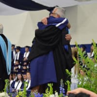 <p>A hug for a happy graduate. </p>