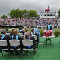 <p>The graduates look out onto the crowd. </p>