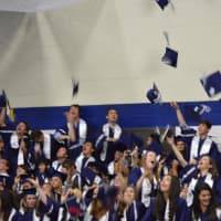 <p>The graduates at Staples High School throw their mortarboards into the air at the end of Thursday&#x27;s ceremony.</p>