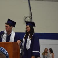 <p>Students Edward Coogan and Pamela Onorato tell the seniors to turn their tassels. </p>