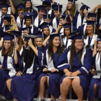 <p>The students are turning their tassels as the graduation becomes official.</p>
