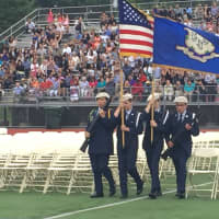 <p>Members of the AFJROTC carry flags in to the football field at Norwalk High School Thursday.</p>