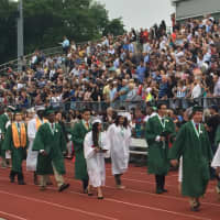<p>The Norwalk High School Class of 2015 walks off the field to thunderous applause from the audience after graduating Thursday.</p>