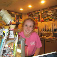 <p>Kelly Sullivan scooping ice cream at Main Street Sweets in Tarrytown</p>