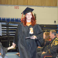 <p>A Ridgefield High graduate accepts a quick congratulations at the commencement on Friday at Western Connecticut State University. </p>