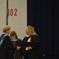 <p>A retiring faculty member receives a certificate. </p>