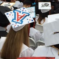 <p>Graduates show off decorated mortarboards for graduation -- and say goodbye to high school.</p>