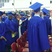 <p>A graduate waves to the camera just prior to the start of the ceremonies.</p>