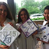 <p>From left, Amanda Greenberg, Brittany Sullivan and Lydia Parapimon, hold up their mortarboards.</p>