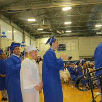<p>Dobbs Ferry&#x27;s Mia Elizabeth Becerra eagerly awaits her diploma while lined up behind Noah Baron and Class of 2015 Salutatorian Jacob Ascher.</p>