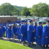 <p>Members of Horace Greeley High School&#x27;s class of 2015 walk to their graduation tent.</p>