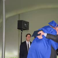 <p>Chappaqua school board member Jeffrey Mester hugs his son, AJ, as he gets his diploma.</p>