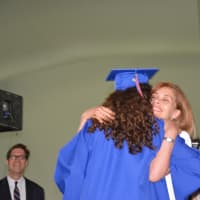 <p>Chappaqua school board member Victoria Tipp hugs her daughter, Madeleine, as she collects her diploma.</p>
