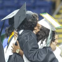 <p>Faculty members offer hugs for the graduates. </p>