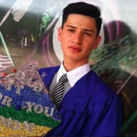 <p>Bryan Silva holds his mortarboard with a special message for his mother, Rosa Sanabria, who couldnt attend his graduation ceremony. </p>