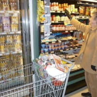 <p>Sheila Whitney, of Greenburgh, stocks up on canned goods at the A&amp;P Supermarket in Greenburgh Shopping Center.</p>