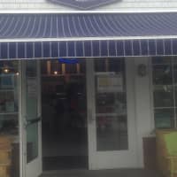 <p>Saugatuck Sweets, located on the banks of the river, has a distinctive blue awning. </p>
