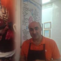 <p>Owner and ice cream maker Tony Nascimento mans the counter at Il Bacio in Danbury. He is famous for his handcrafted frozen treats. </p>