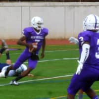 <p>New Rochelle quarterback Khalil Edney avoids a tackler and sets to pass.</p>