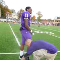 <p>Joe Clarke, the New Rochelle lineman, tight end and kicker, has his shoes changed for a kickoff.</p>