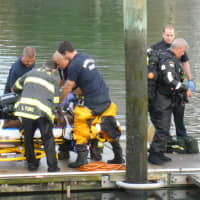 <p>Norwalk emergency personnel perform CPR on one of the victims pulled from a submerged car at Veterans Memorial Park Saturday. </p>