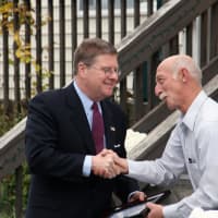 <p>Westchester County Legislator Peter Harckham, left, shakes hands with Charlie Voelkl of the Northern Westchester Country Club.</p>
