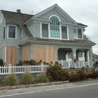 <p>Boards cover the windows of a home on Soundview Drive near Compo Beach in Westport in preparation of Hurricane Sandy. </p>