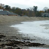 <p>A wall of sand extends along Compo Beach Sunday before the arrival of Hurricane Sandy.</p>