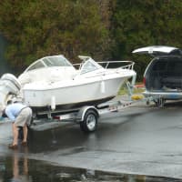 <p>A resident pulls his boat out from the Ned Dimes Marina at Compo Beach in Westport Sunday.</p>