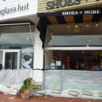 <p>Fearing the Saugatuck River will overflow its banks downtown, several Main Street businesses placed sandbags and plastic tarps outside their stores Sunday.</p>