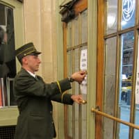 <p>Assistant Station Master Cory Harris locks the main entrance to Grand Central Terminal, at 42nd Street and Park Avenue, after the last train departed at 7:10 p.m. Sunday  in advance of Hurricane Sandy.</p>