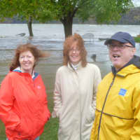 <p>Bridget Clarke, left, Nancy DeNatale and Mike DeNatale visit the Hudson River in Hastings Monday to witness the effects of Hurricane Sandy.</p>